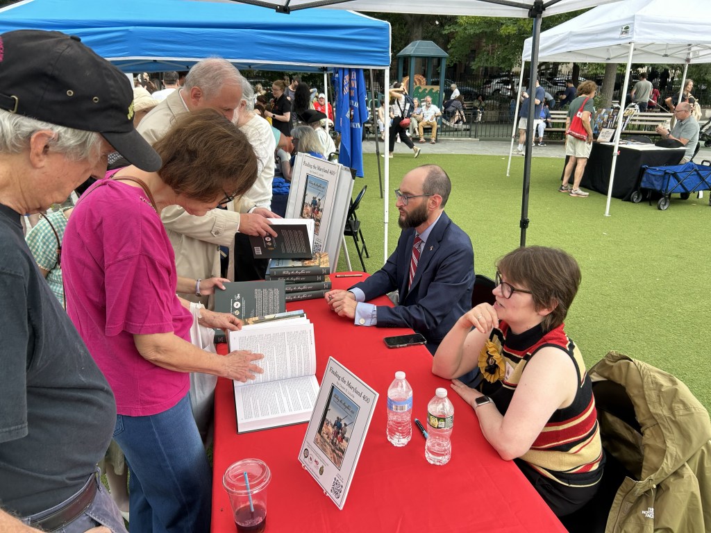 Author Owen Lourie of the Maryland State Archives signs copies of Finding the Maryland 400 In Brooklyn, NY on August 22, 2023.